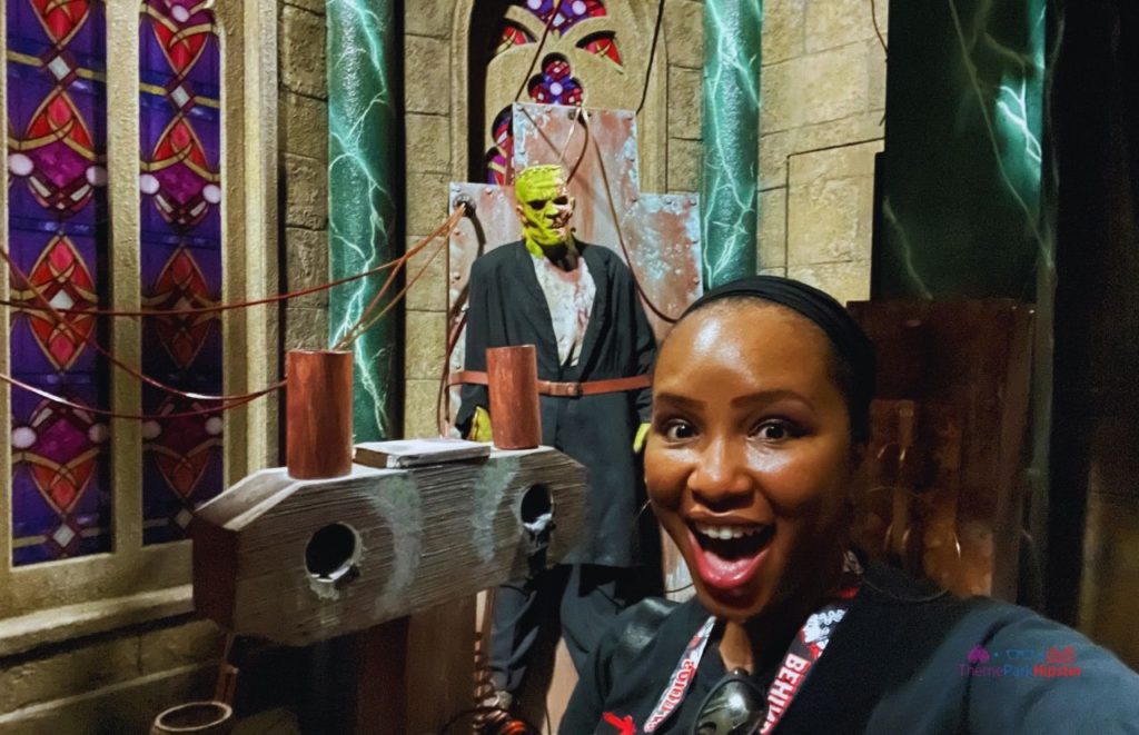 Universal Monsters The Bride of Frankenstein Lives HHN 30 NikkyJ of ThemeParkHipster in front of monster for the Halloween Horror Nights Unmasking the Horror Lights On Tour