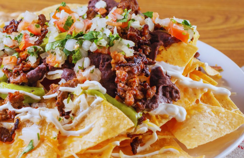 Beef Nachos Loaded with onions lettuce tomatoes and beans at Disney World at Pecos Bill. One of the best quick service and counter service restaurants at Magic Kingdom.