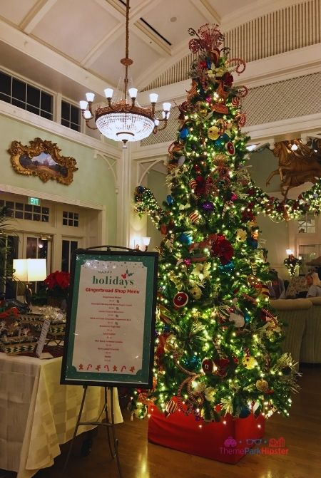 Disney Boardwalk Inn Christmas Tree with Gingerbread Shop Menu. Keep reading to learn about the Disney World Gingerbread house display on Theme Park Hipster!