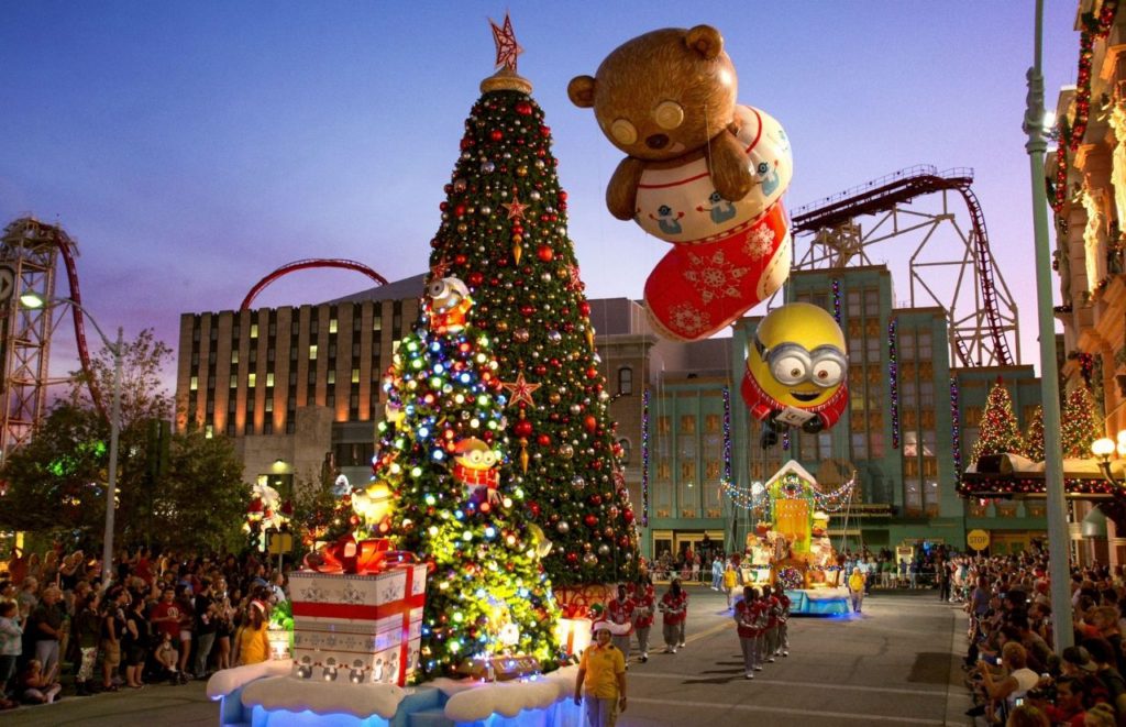 Macys Holiday Parade with Large Minion and Teddy Bear Float Overlooking Universal Studios Roller Coasters