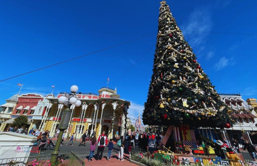Magic Kingdom Christmas Tree with Cinderella Castle in the background. Keep reading to get the best Disney at Christmastime tips for your trip!