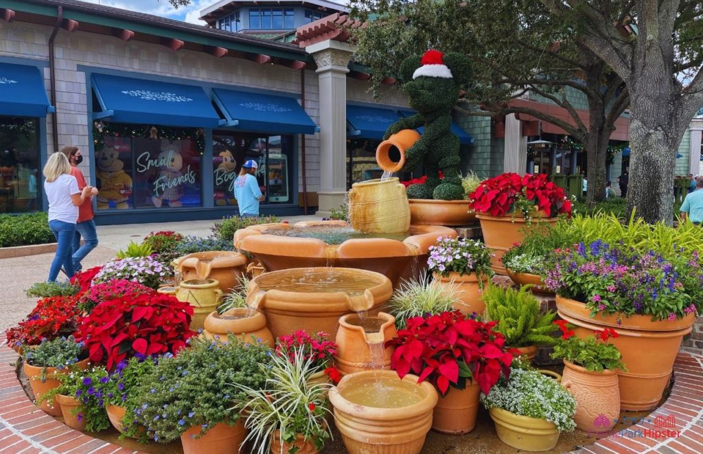 Mickey Mouse Fountain in Disney Springs with Christmas Decorations. Keep reading to get the best Disney at Christmastime tips for your trip!