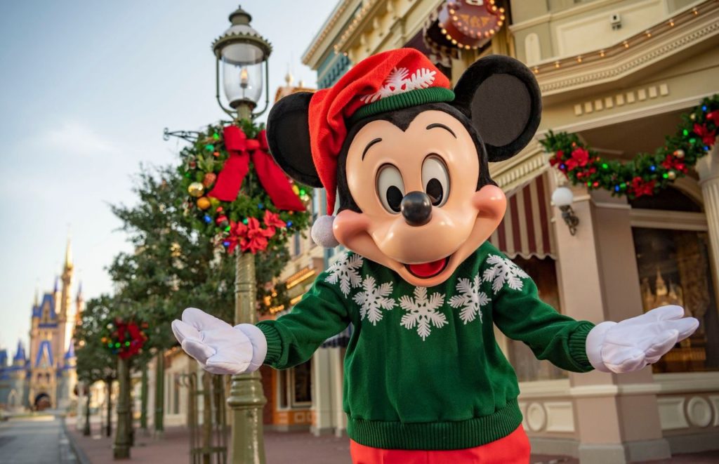 Mickey Mouse on Main Street USA for Christmas at Disney Magic Kingdom. Keep reading to get the best Disney Christmas songs!