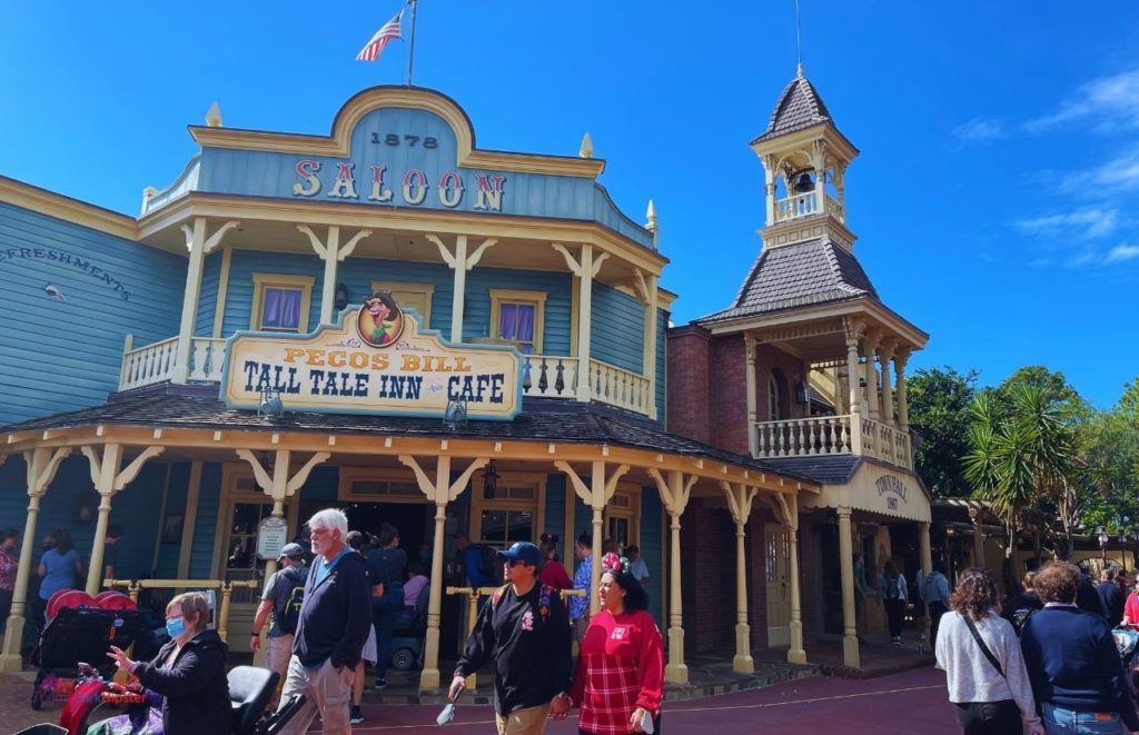 Pecos Bill Tall Tale Inn Café entrance in a rustic old Americana 1878 saloon at Magic Kingdom, Orlando, Florida. Keep reading to learn more about the best place to watch Magic Kingdom fireworks.