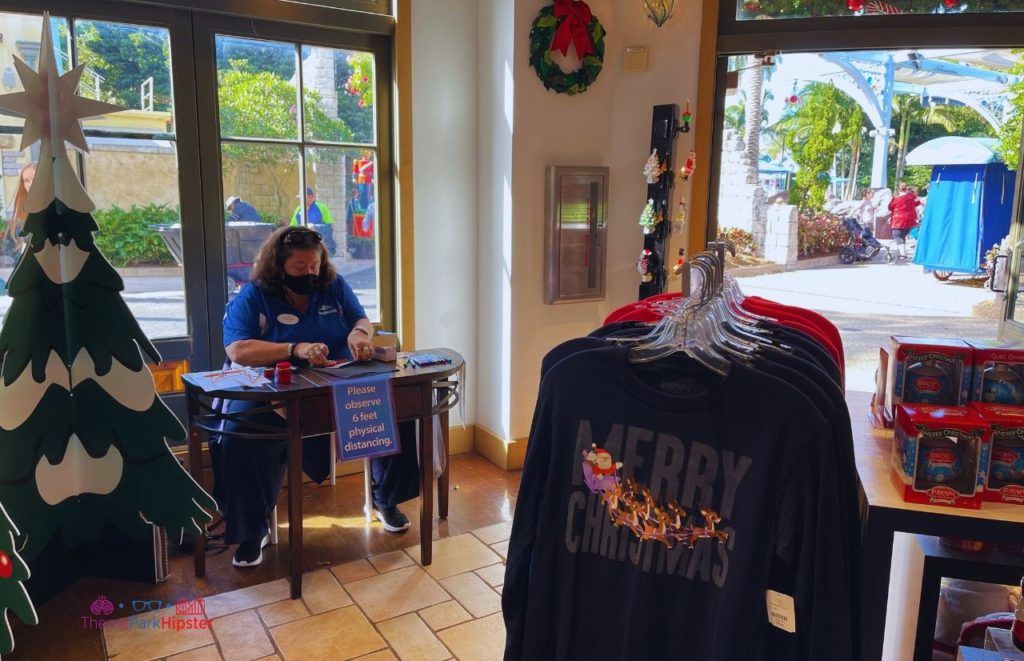 SeaWorld Christmas Celebration Lady Personalizing Holiday Ornaments. Keep reading to learn about Christmas at SeaWorld Orlando!