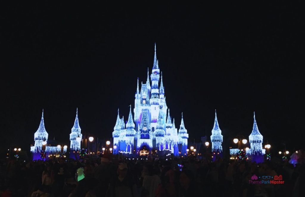 Shimmering Cinderella Castle with Christmas Lights at the Magic Kingdom Lake Buena Vista Florida. Keep reading to learn about the best Magic Kingdom shows and why you'll want to stick around to watch a Magic Kingdom night show.