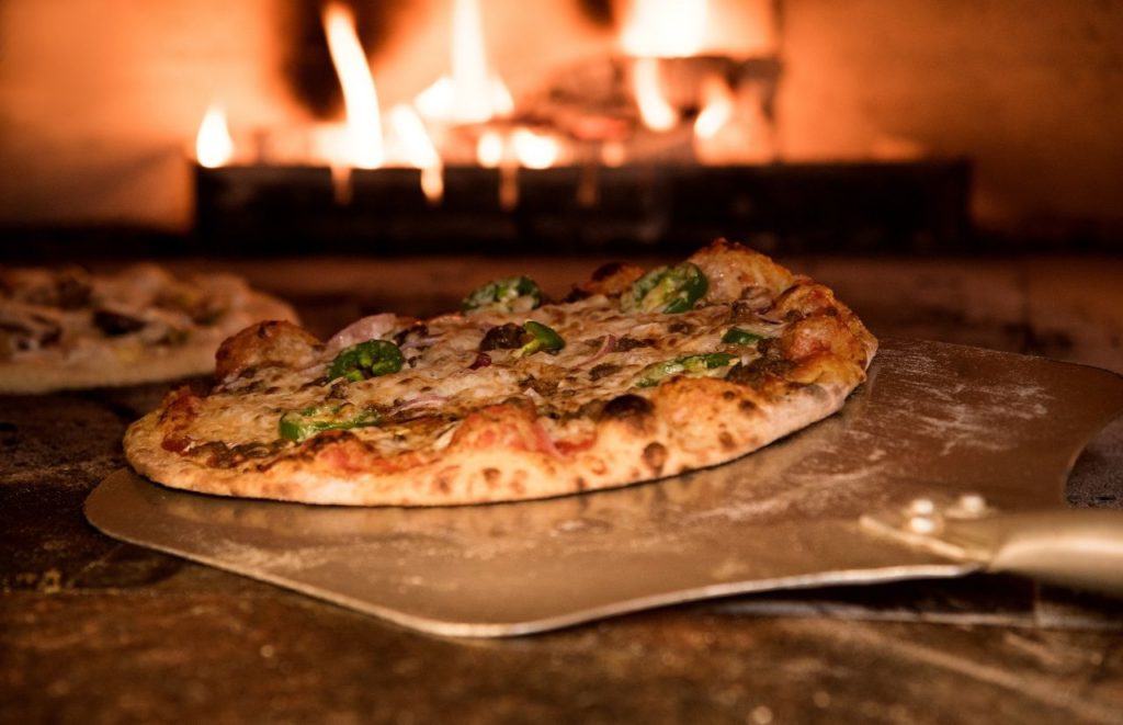 Pizza in a fire oven at Disney. Keep reading for all you need to know about the best Italian restaurants at Disney World.