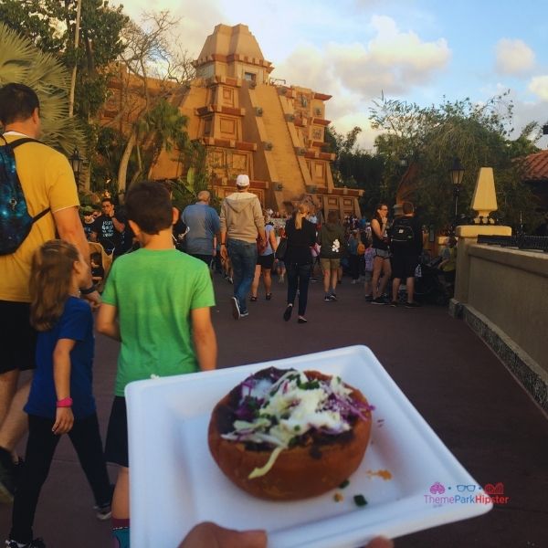 Mexican cheese and black black beans on top of flaky bread at Epcot Festival of the Arts. Keep reading to get the full Epcot Festival of the Arts Menu!