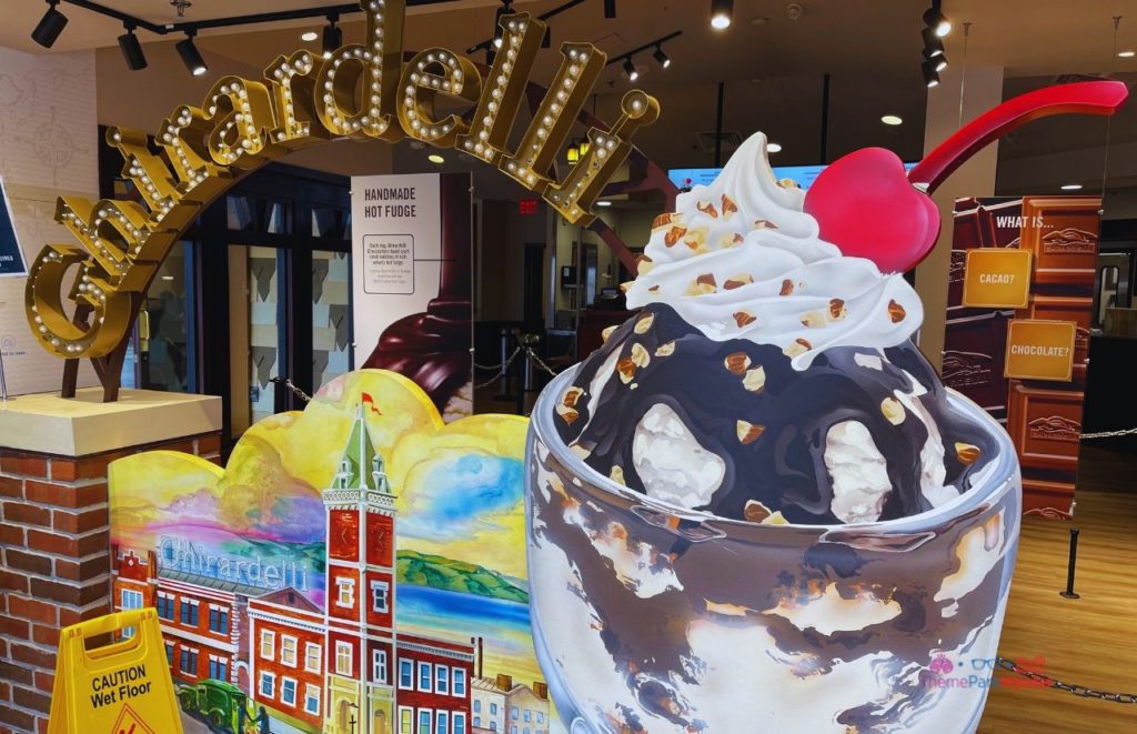 Disney Springs Ghirardelli Soda Shop Dessert entrance, showcasing larger than life decor of a sundae with syrup nuts and a big cherry on top. Keep reading to learn the 25 most romantic things to do at Disney World for couples. 
