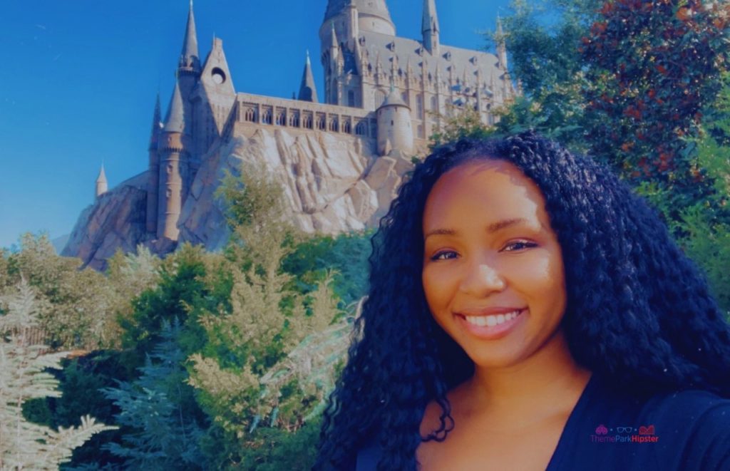 NikkyJ in front of Hogwarts Castle Forbidden Journey Harry Potter Ride. Keep reading to get the best Universal Islands of Adventure tips and tricks.