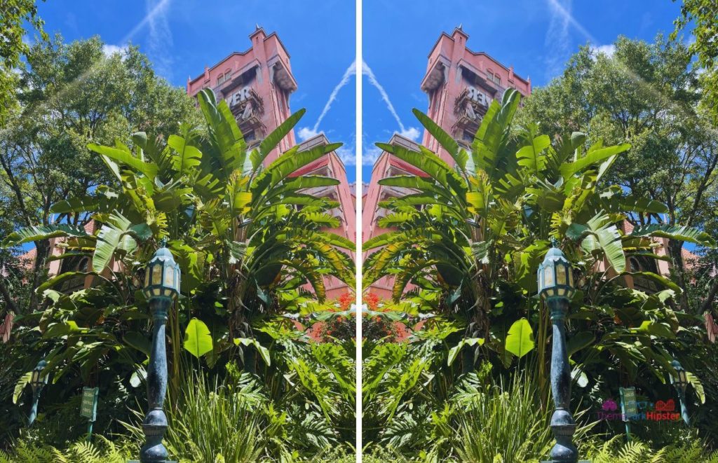 Overgrown palms outside the façade of The Hollywood Tower Hotel, home of The Twilight Zone Tower of Terror at Disney World  Hollywood Studios. If you want to take deep dive into Twilight Zone Tower of Terror: Secrets REVEALED, keep reading!