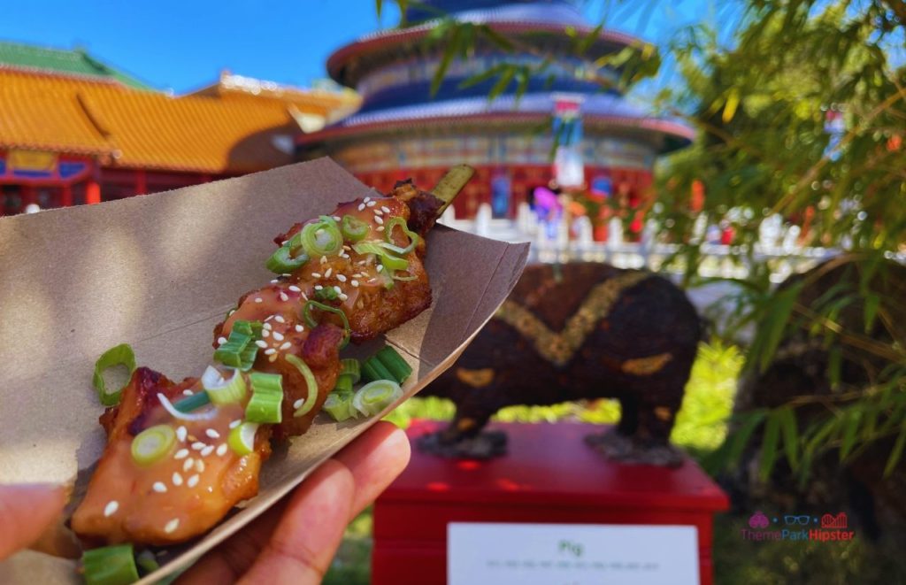 Epcot China Pavilion Flower and Garden Festival Chicken Skewer. Keep reading to learn how to go to Epcot Flower and Garden Festival alone and how to have the perfect solo Disney World trip.