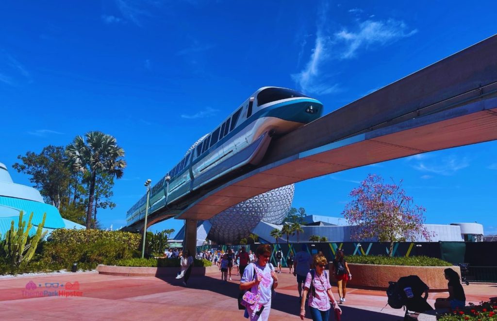 Epcot Flower and Garden Festival monorail passing by Spaceship Earth next to The Seas with Nemo. Keeping reading to learn about doing Epcot for adults and Disney for grown-ups.