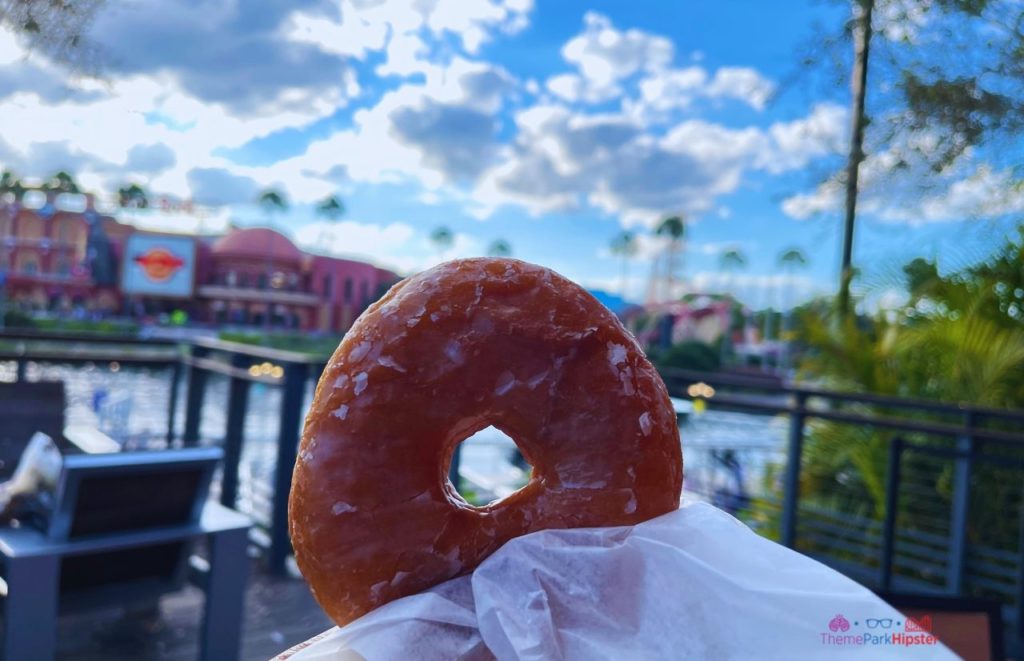 Glaze donut at Voodoo Doughnuts in Universal Orlando CityWalk. Keep reading to learn about the cheap, best food at Universal Studios Orlando, Florida.