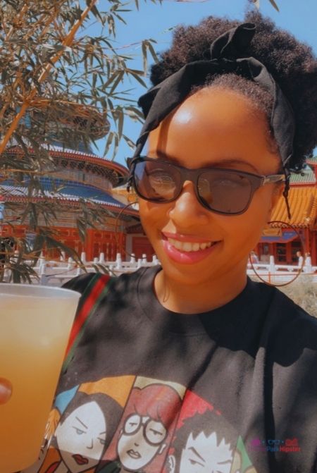 NikkyJ at Epcot Flower and Garden Festival 2024 China Pavilion. Keep reading to get the best Epcot drinking around the world shirts.
