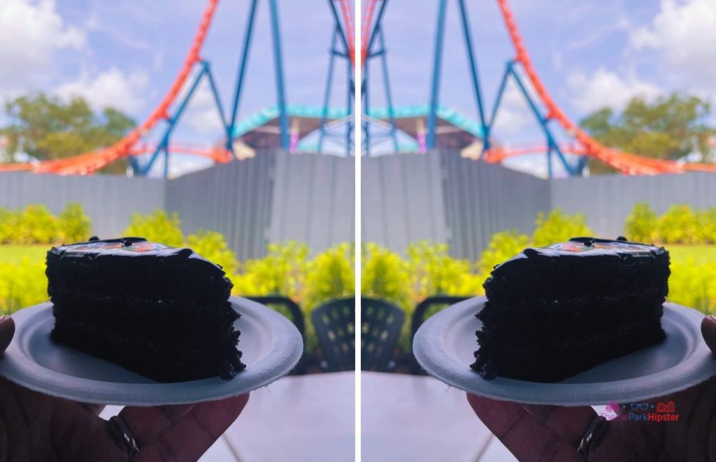 SeaWorld Orlando Chocolate Cake in front of Icebreaker Roller Coaster. Keep reading to learn if the SeaWorld All Day dining plan is worth it.