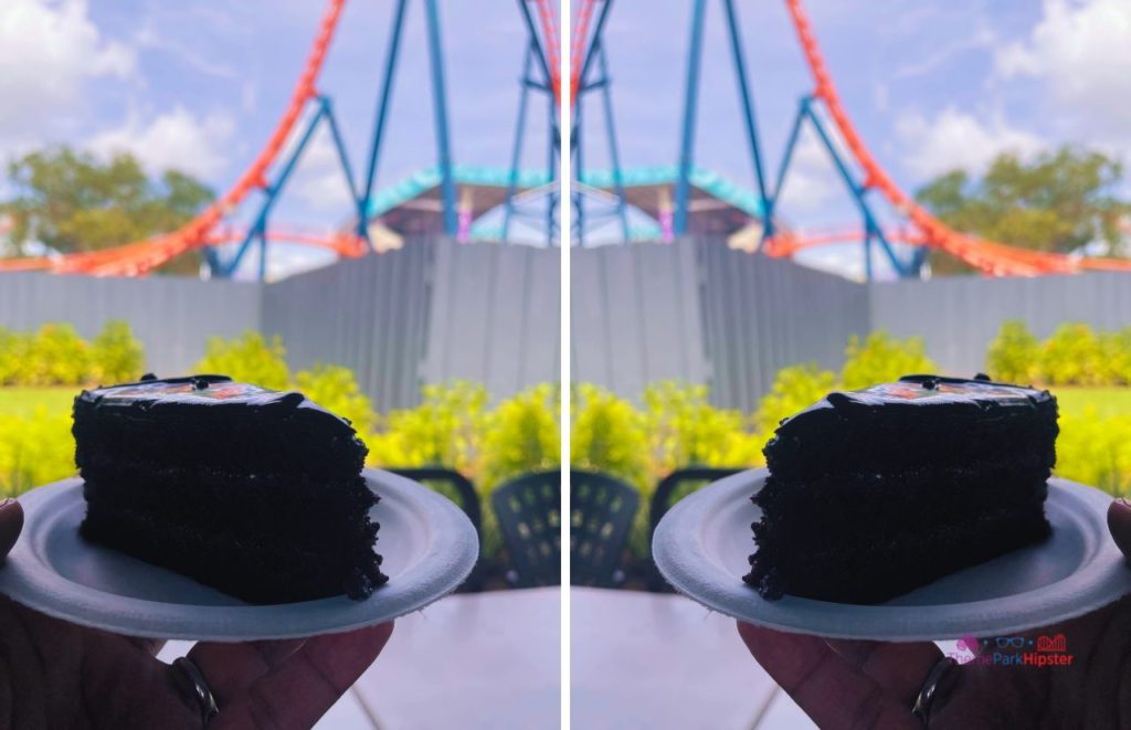 SeaWorld Orlando Chocolate Cake in front of Icebreaker Roller Coaster. Keep reading to learn if the SeaWorld All Day dining plan is worth it.