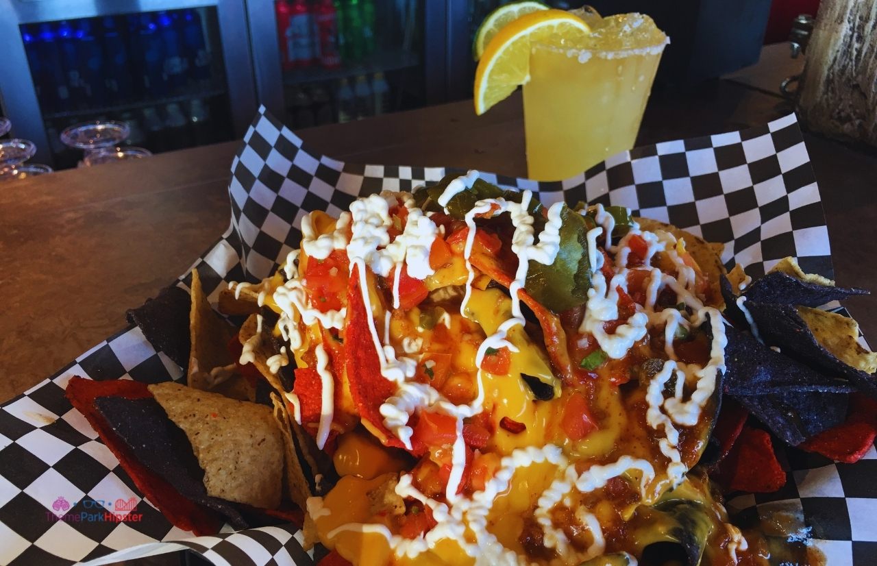 SeaWorld Orlando Loaded Nachos and Margarita at Flamecraft Bar. Keep reading to learn more about the best SeaWorld Orlando restaurants.