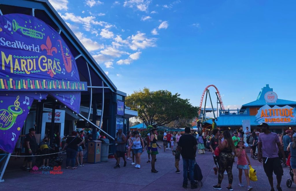 SeaWorld Orlando Mardi Sign next to Altitude Burgers. Keep reading to learn how to avoid with SeaWorld wait times with quick queue skip the line pass.