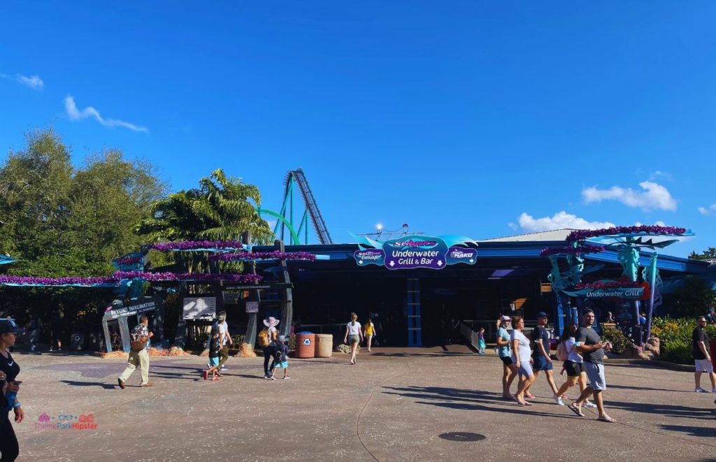 Sharks Underwater Grill and Bar at SeaWolrd Orlando with Mako and Kraken in the background. Keep reading to learn about the SeaWorld Annual Pass and Pass Member Perks and Benefits.
