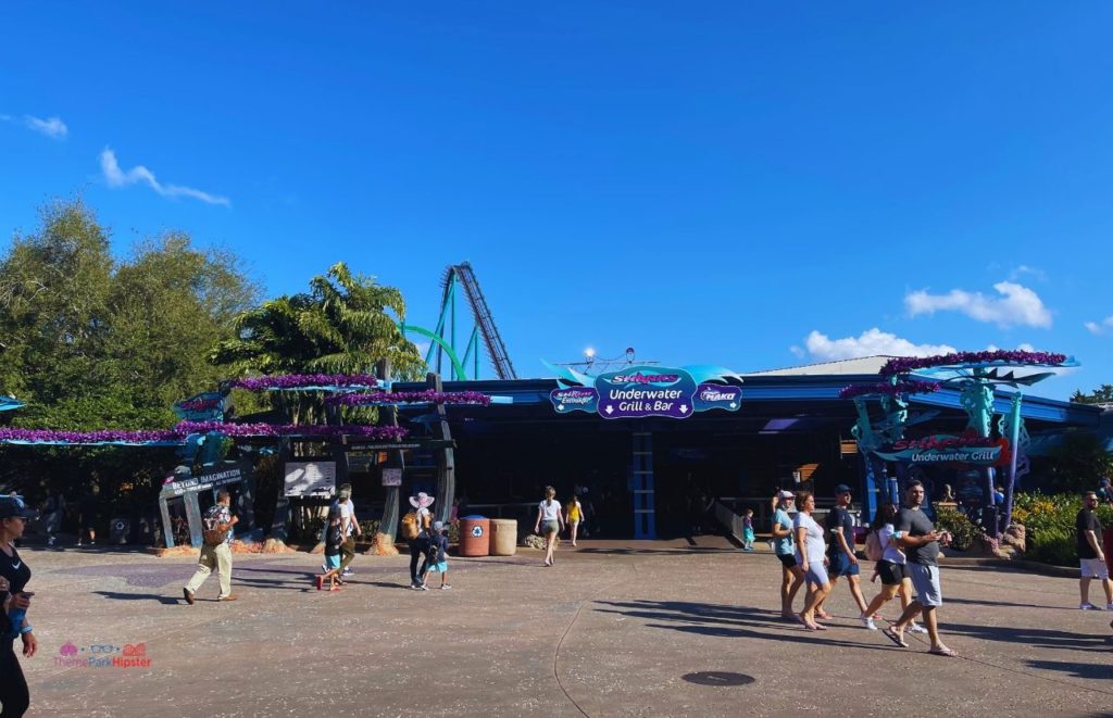 Sharks Underwater Grill and Bar at SeaWolrd Orlando with Mako and Kraken in the background. Keep reading to learn about the 2024 SeaWorld Annual Pass and Pass Member Perks and Benefits.