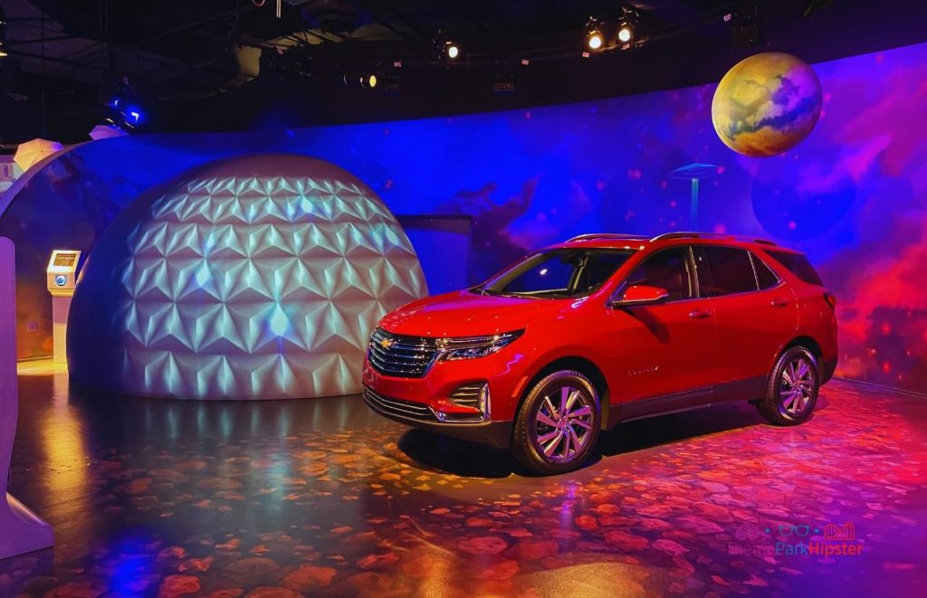 Test Track Epcot Chevrolet Showroom with red truck next to spaceship earth