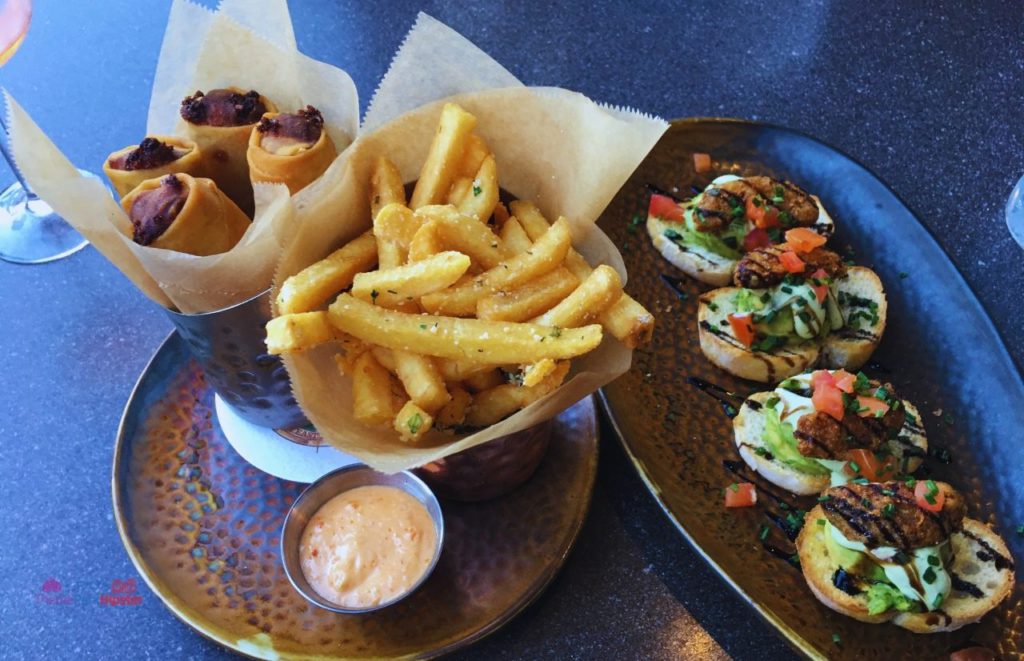 Toothsome Chocolate Emporium Philly Cheesesteak Egg Rolls with Fries and Avocado topped Toast Universal Citywalk. One of the best restaurants in Universal Orlando CityWalk.