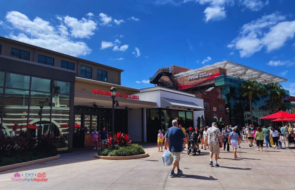 Wolfgang Puck Bar and Grill and Coco Cola Store at Disney Springs. Keep reading to get the best things to do at Disney Springs for solo travelers on a solo disney world trip.