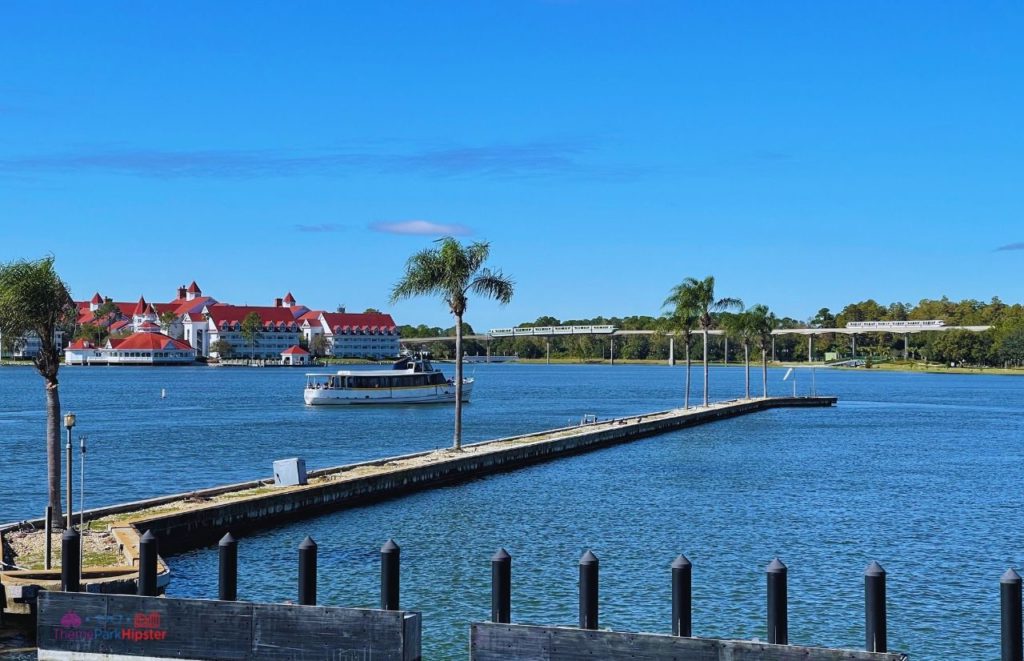 Disney Magic Kingdom Boat on Bay Lake Lagoon overlooking Grand Floridian Resort. Keep reading to know which is better Disney World vs Universal Studios.