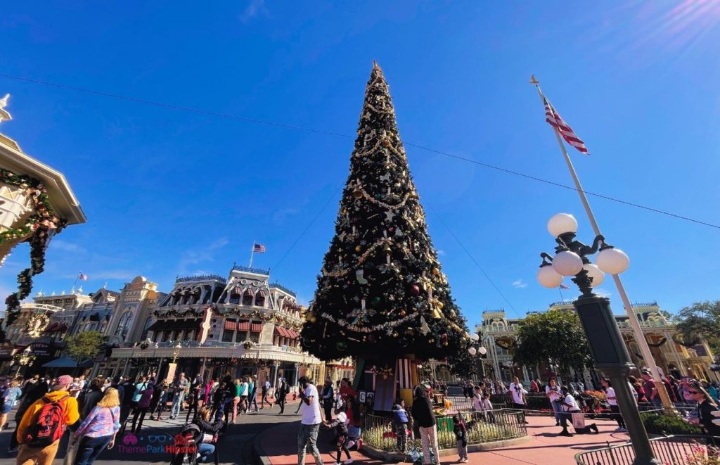 Disney Magic Kingdom Christmas tree in the Florida sun. Keep reading to get the best Disney at Christmastime tips for your trip!
