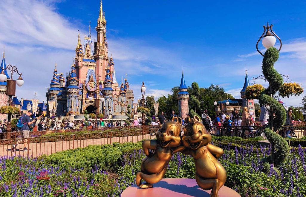 Disney Magic Kingdom at Christmas Cinderella Castle with Chip n Dale 50th Anniversary Statues. Keep reading to get get the best solo travel safety tips for your Disney World trip alone.