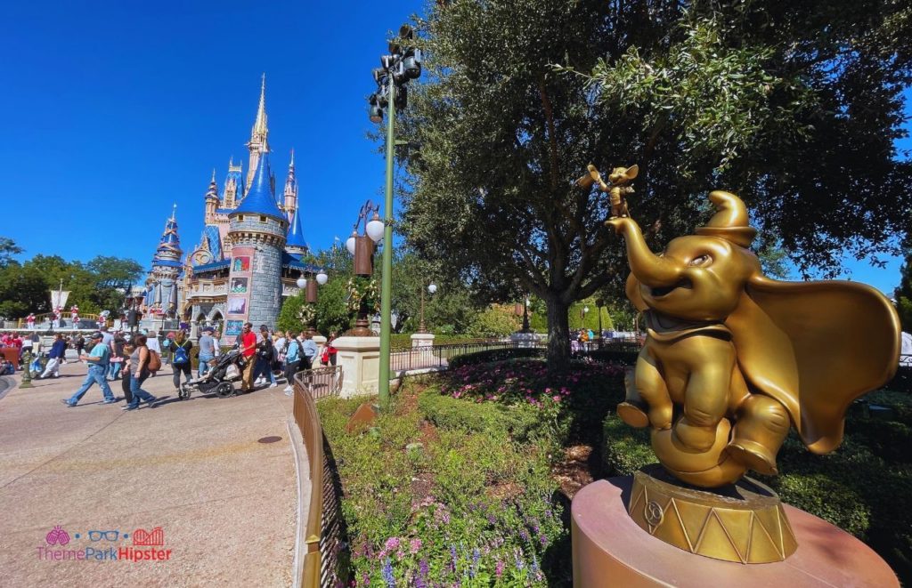 Disney Magic Kingdom Cinderella Castle with Dumbo 50th Anniversary Statue. 2024 Disney World height requirements.