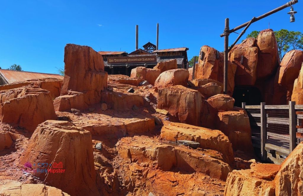 Disney Magic Kingdom Rocky Entrance in front of Big Thunder Mountain Railroad. Best Roller Coasters at Disney World all ranked! Keep reading for the full list of Disney rides.