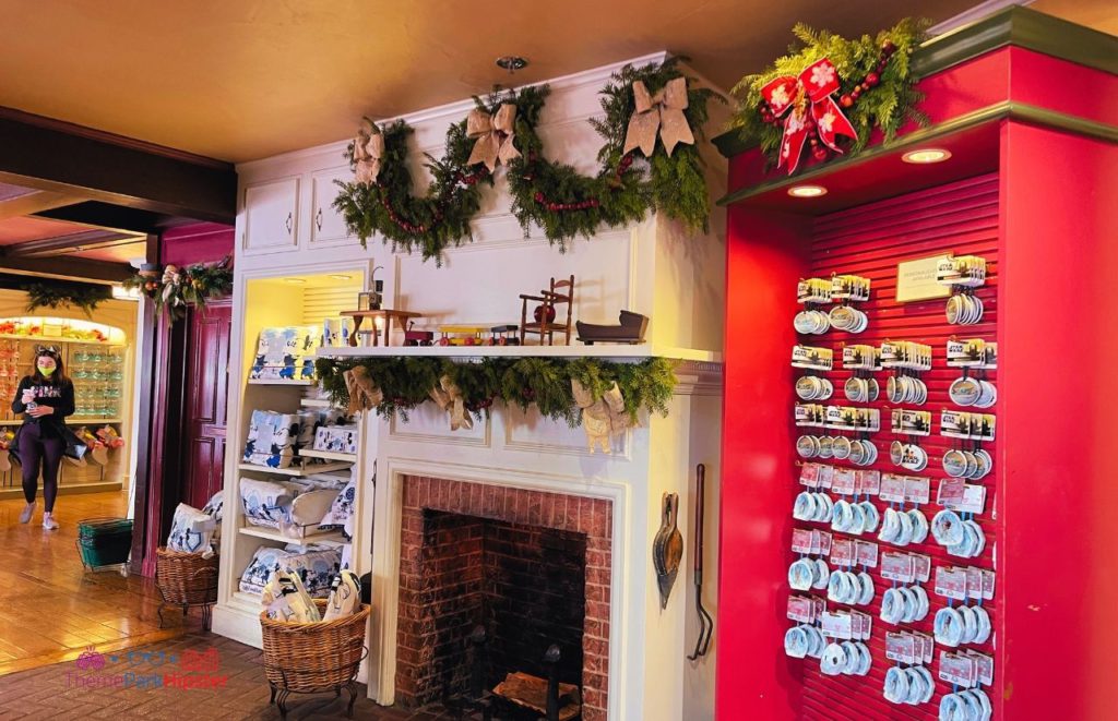Disney Magic Kingdom Ye Olde Christmas Shoppe in Liberty Fireplace. Keep reading to get the best things to do at the Magic Kingdom for Christmas and a full guide to Mickey's Very Merry Christmas Party Tips!