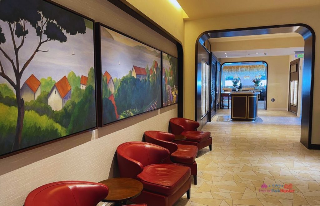 Topolino’s Terrace at Disney’s Riviera Resort waiting area with artwork