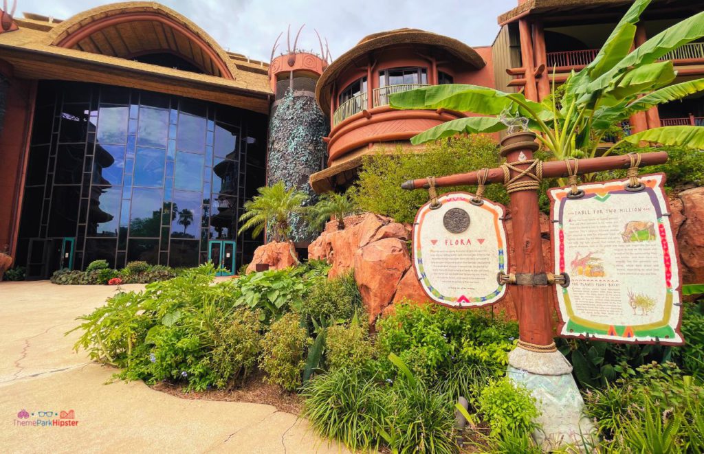 Animal Kingdom Lodge back entrance view with tall building covered in windows decorated with gardens full of foliage outside. Keep reading to learn more about the best things to do at Disney World for solo travelers.