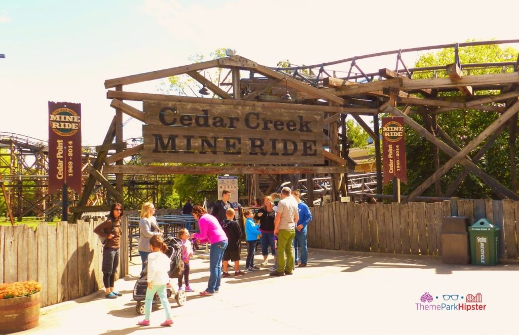 Cedar Point Cedar Creek Mine Ride Roller Coaster entrance with visitors of all ages standing in front. Keep reading to learn more about the best things to do at Cedar Point. 