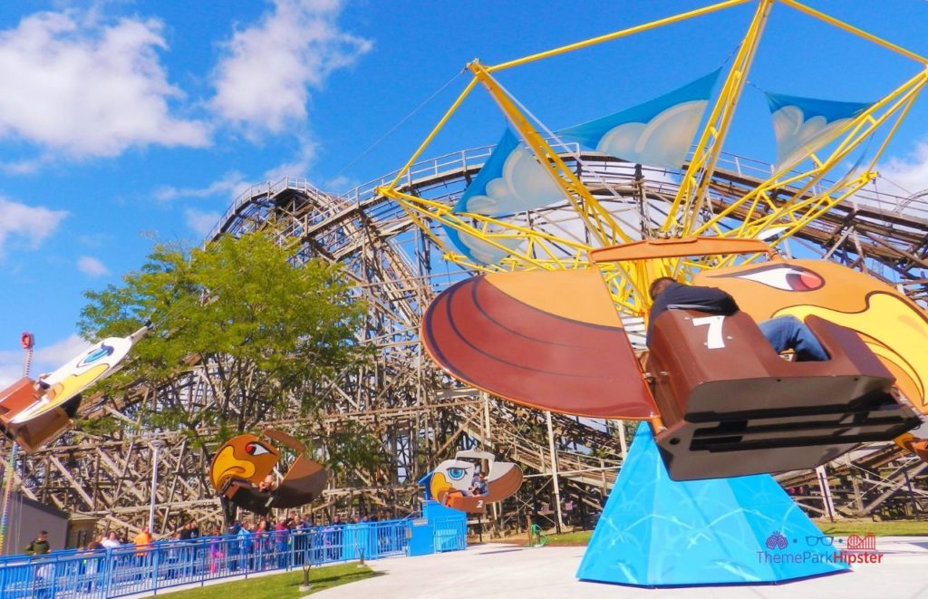 Cedar Point Gemini Roller Coaster behind kiddie ride. Keep reading for more Cedar Point tips and tricks for beginners.