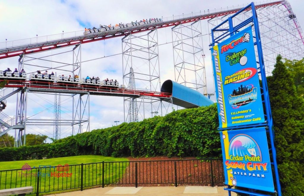Cedar Point Magnum XL lift hill and tunnel on roller coaster with soak city sign. Keep reading to learn about the best Cedar Point roller coasters ranked!