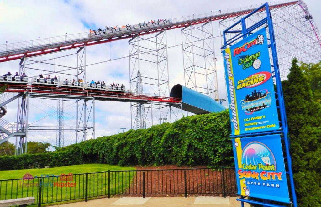 Cedar Point Magnum XL lift hill and tunnel on roller coaster with soak city sign. Keep reading to learn about the tallest roller coasters at Cedar Point.