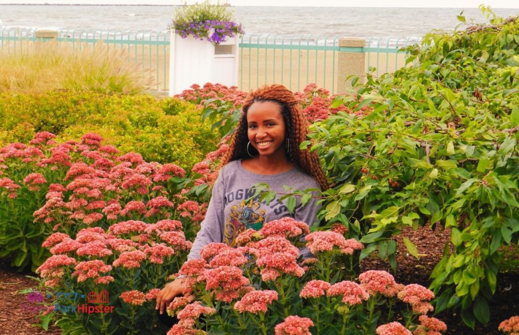 Editor NikkyJ in colorful foliage at Hotel Breakers, Cedar Point with Lake Erie shoreline in the background. . Keep reading to find out the best things to do at Cedar Point. 