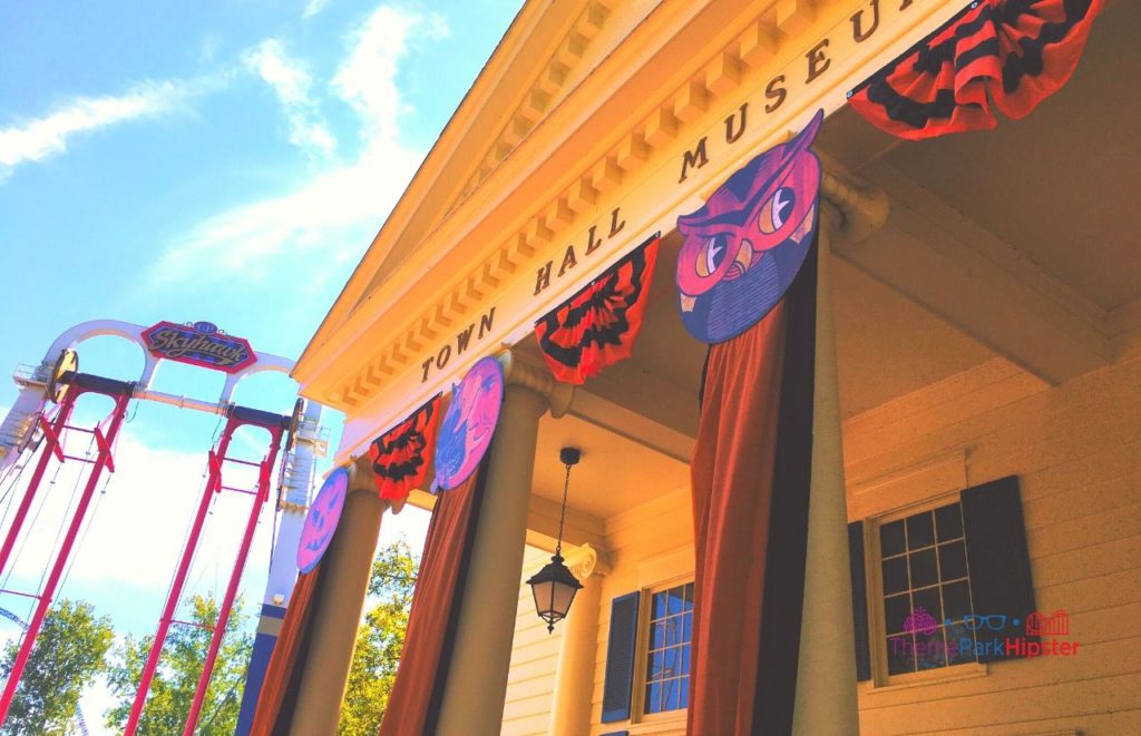 Cedar Point Town Hall Museum in Halloween Decor next to Skyhawk. Keep reading to see where to find cheap Cedar Point tickets at a discount.