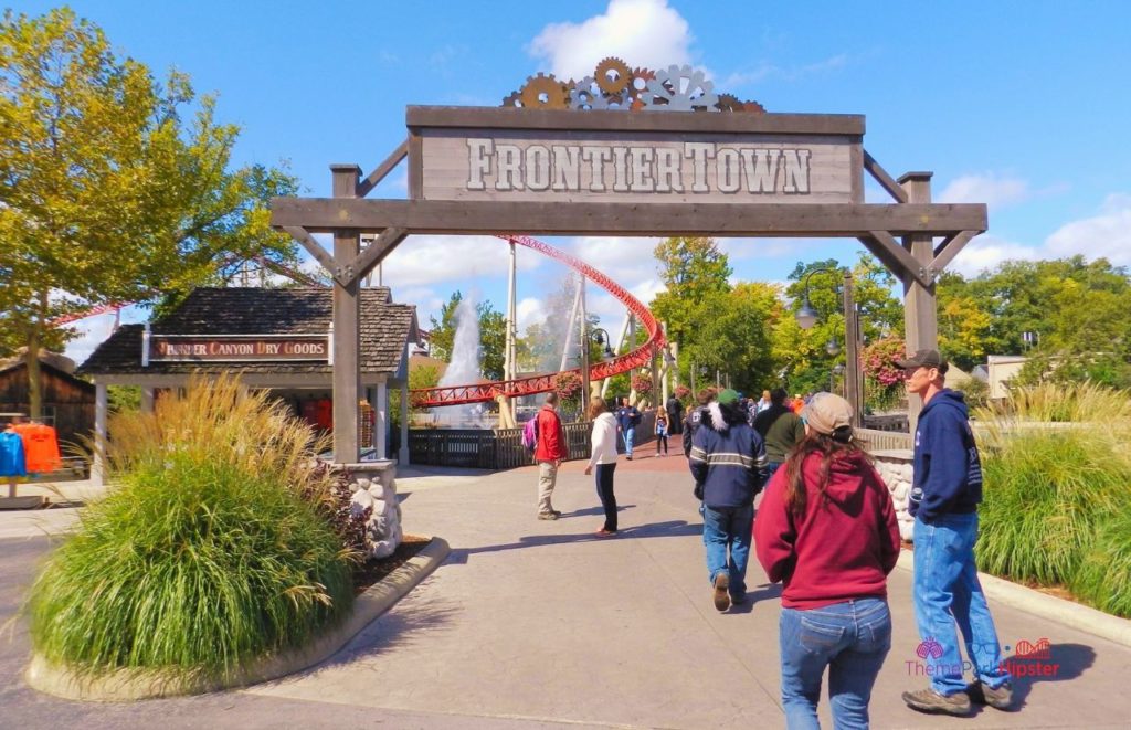 Cedar Point Walking Into Frontier Town with Maverick in the background. Keep reading to see where to find cheap Cedar Point tickets at a discount.