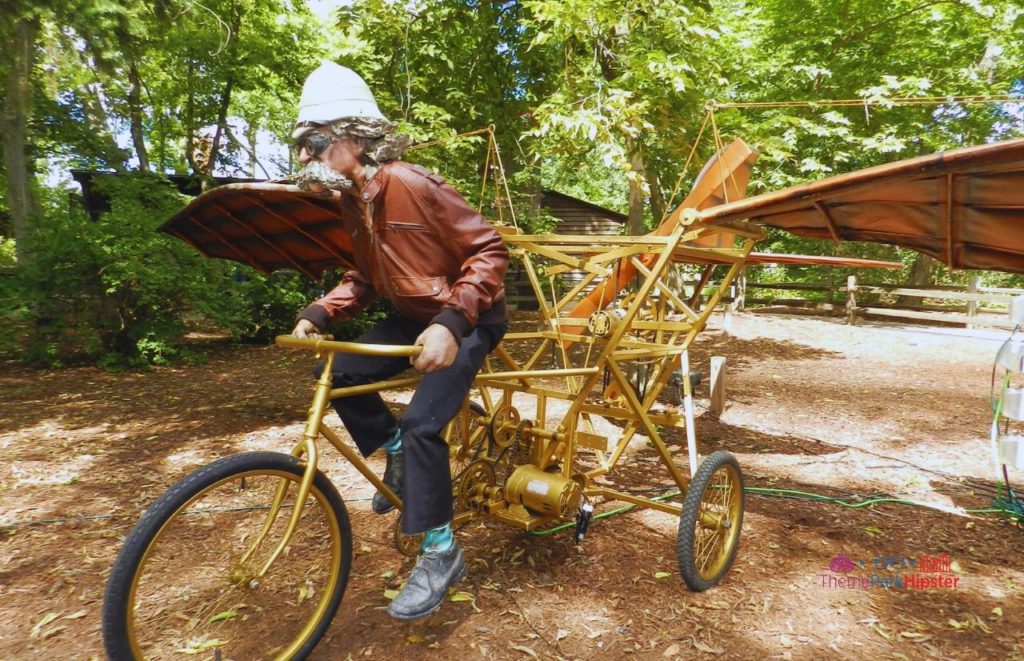 Cedar Point man on gold flying bike in frontiertown. Keep reading for more Cedar Point tips and tricks for beginners.