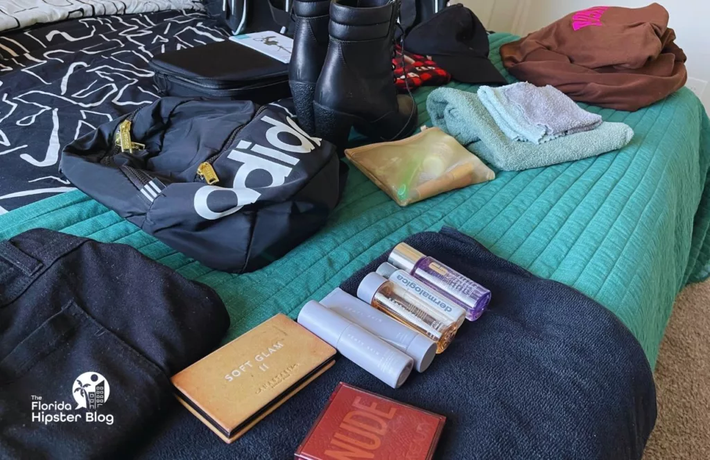 My clothes laid out on the bed for my theme park packing list. One of the Solo Travel Essentials You MUST HAVE to Stay Safe at Walt Disney World