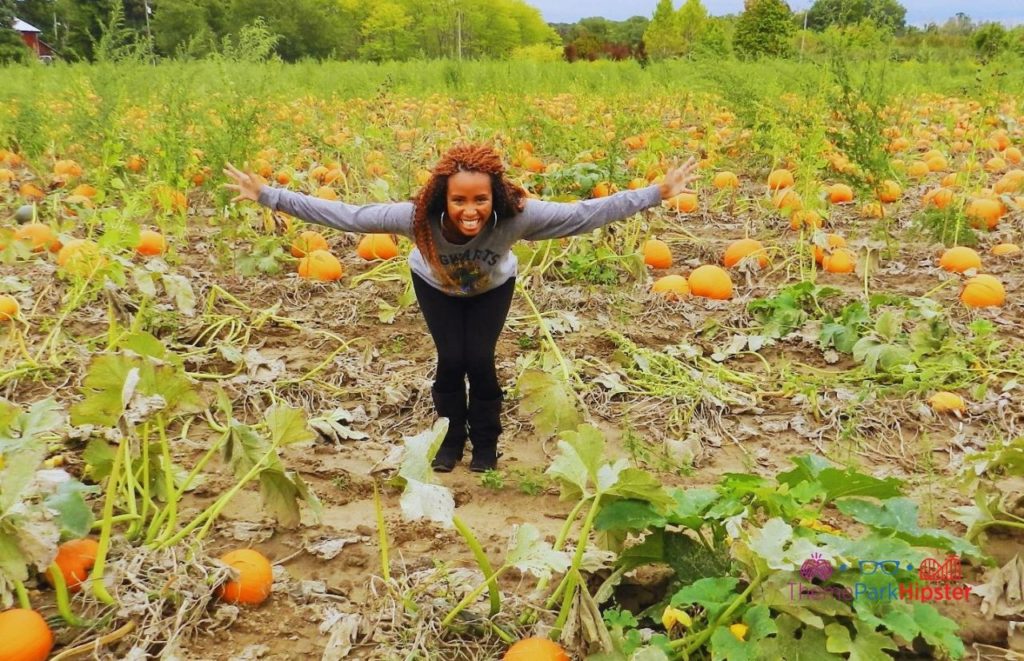 NikkyJ happy in Sandusky, Ohio pumpkin patch on the way to Cedar Point. Keep reading to see why you should do solo travels to theme parks!