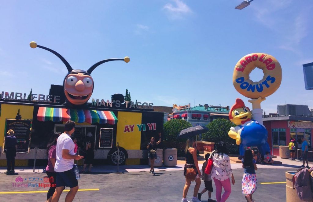 Universal Orlando Resort Bumblebee Mans Taco and Lard Lad Donuts in Springfield at Simpsons Land Universal Studios. Keep reading for the full guide to the BIG Pink Donut from Universal Lard Lad.