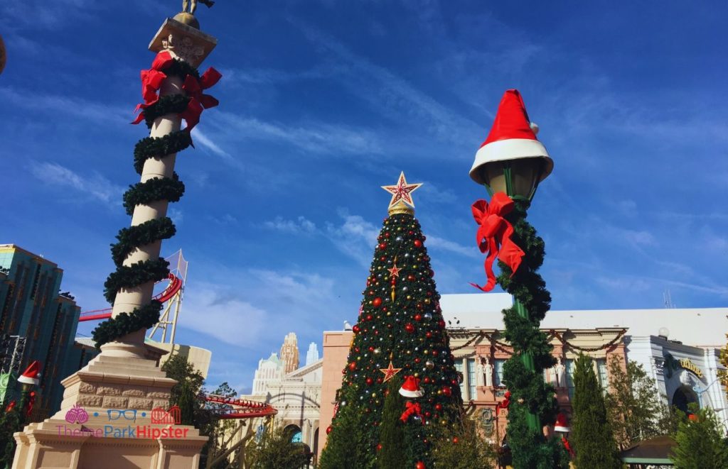 Universal Orlando Resort Giant Christmas Tree in Central Park of Universal Studios Florida. Keep reading to learn about the Universal Studios Crowd Calendar.