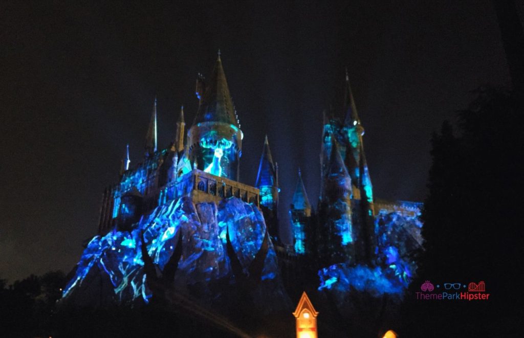 Hogwarts Castle lit up during the Dark Arts Nighttime Show in The Wizarding World of Harry Potter at Hogsmeade at Islands of Adventure, Universal Orlando Resort. Keep reading to learn more about Halloween at Universal