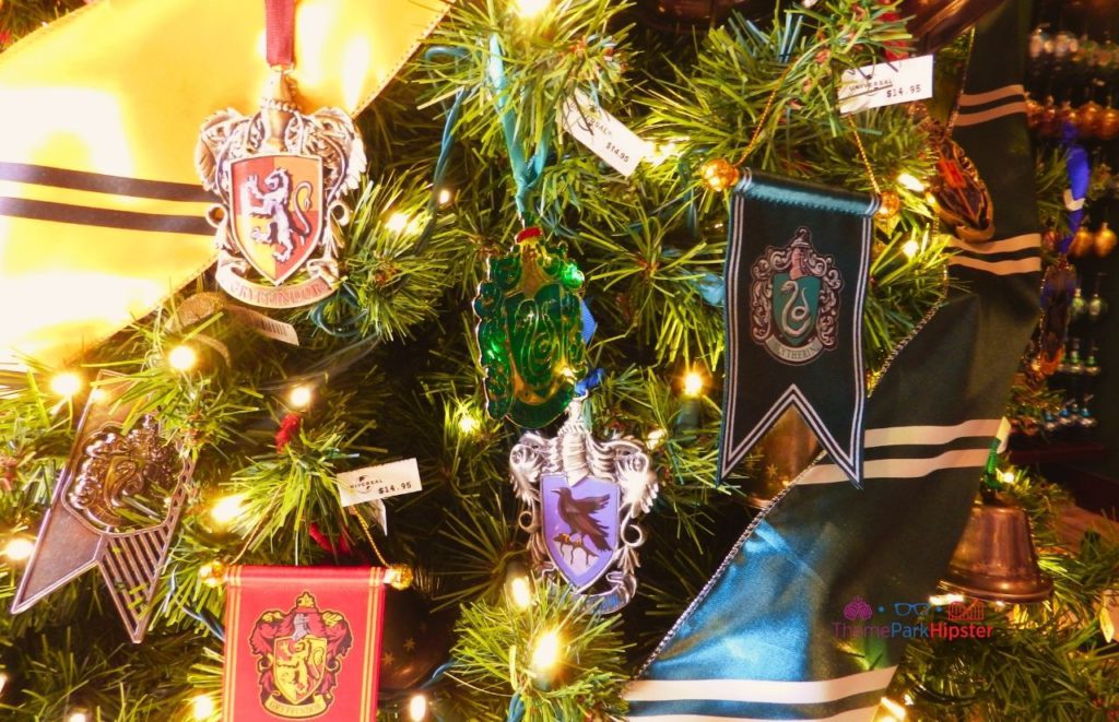 Universal Orlando Resort Hogwarts Houses Christmas Tree Ornaments in The Wizarding World of Harry Potter. Keep reading to learn about Harry Potter World Christmas and Christmas at Hogwarts!